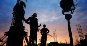 Silhouettes of Workers At A Construction Site